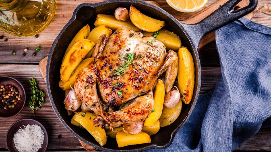 roast chicken and potatoes made in a cast iron skillet
