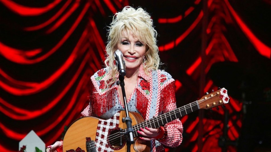 Dolly Parton onstage with guitar
