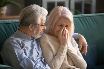 Elder husband soothes, supports frustrated mature wife
