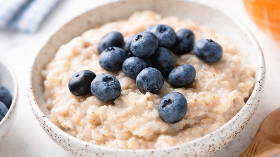 A bowl of oatmeal topped with blueberries