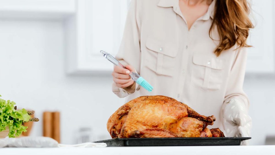 Cropped shot of woman cooking thanksgiving turkey