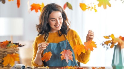 Happy woman doing autumn decor