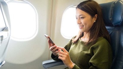 Woman on her phone while on a flight
