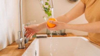 Woman washing an orange