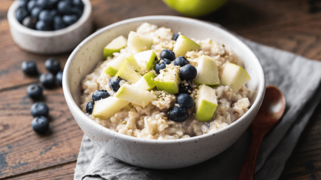 bowl of oatmeal with blueberries and apples