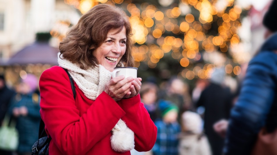 Senior woman on an outdoor Christmas market.