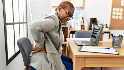 Senior african american woman business worker suffering back pain at office