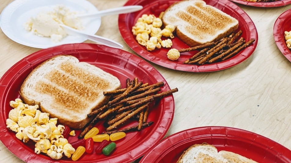 Red plates with toast, pretzel sticks, and jelly beans