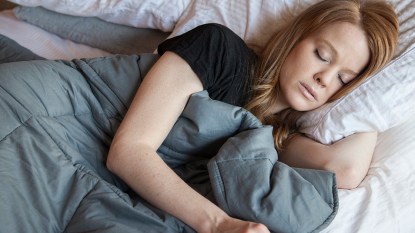 A woman able to get a good night's sleep thanks to her weighted blanket