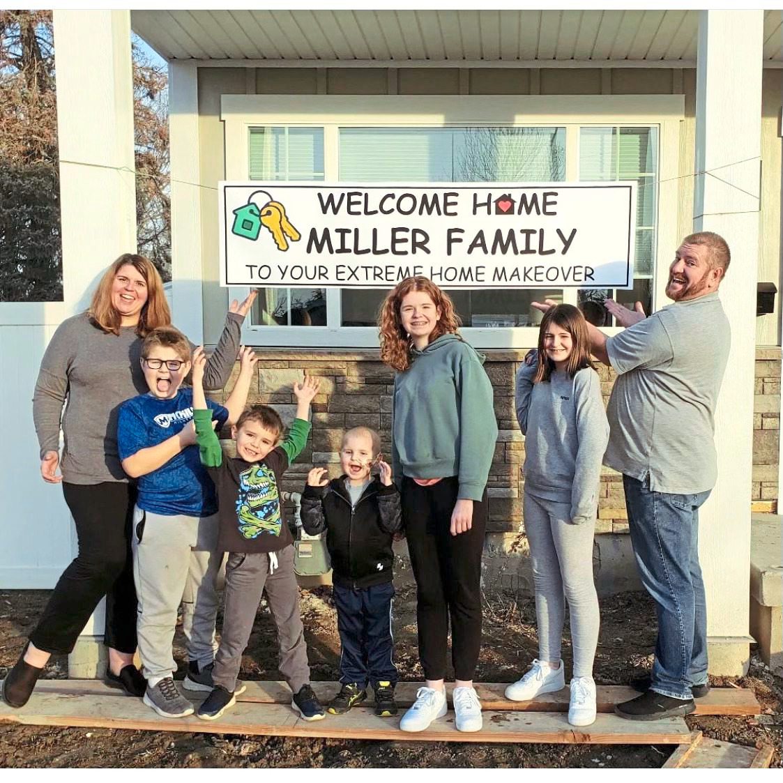 the Miller Family in front of their renovated home