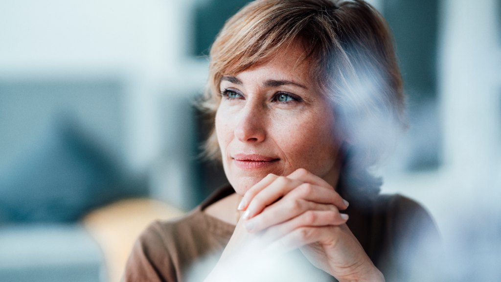 woman looks content as she gazes into the distance