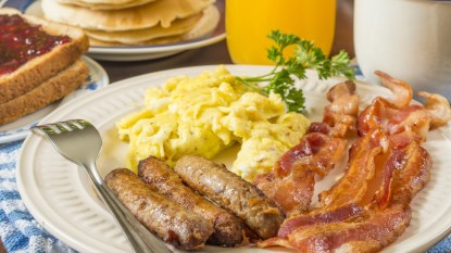 large hot breakfast, eggs, sausage, bacon, concept for boosting metabolism
