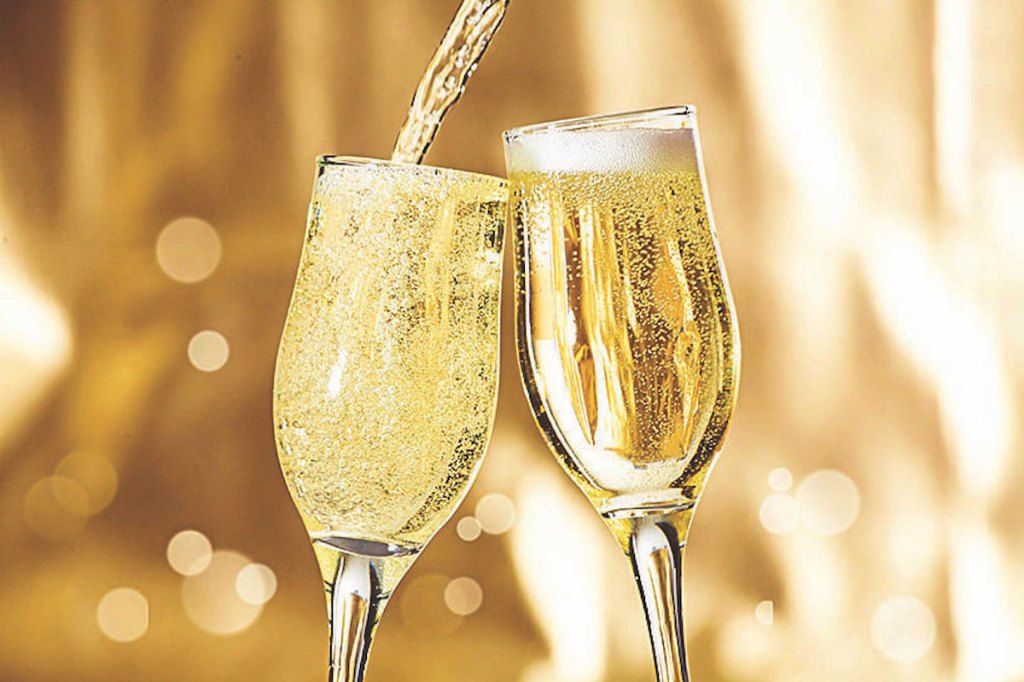 Pair of champagne flutes making a toast.
