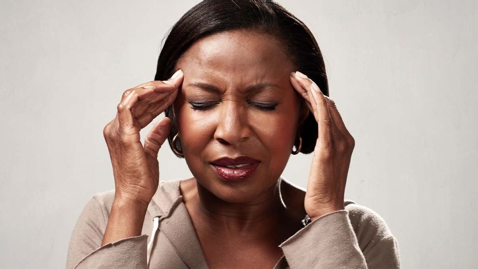 A closeup of a woman with a headache