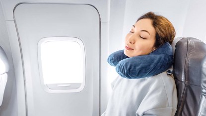A woman sleeping peacefully on a flight