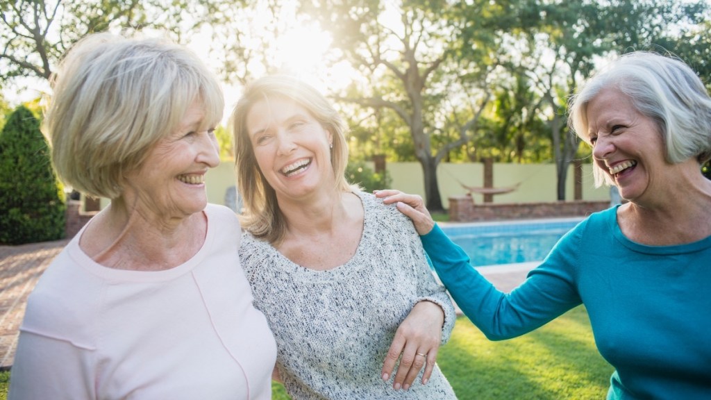 Three older women who are friends, smiling and laughing, which strengthens memory