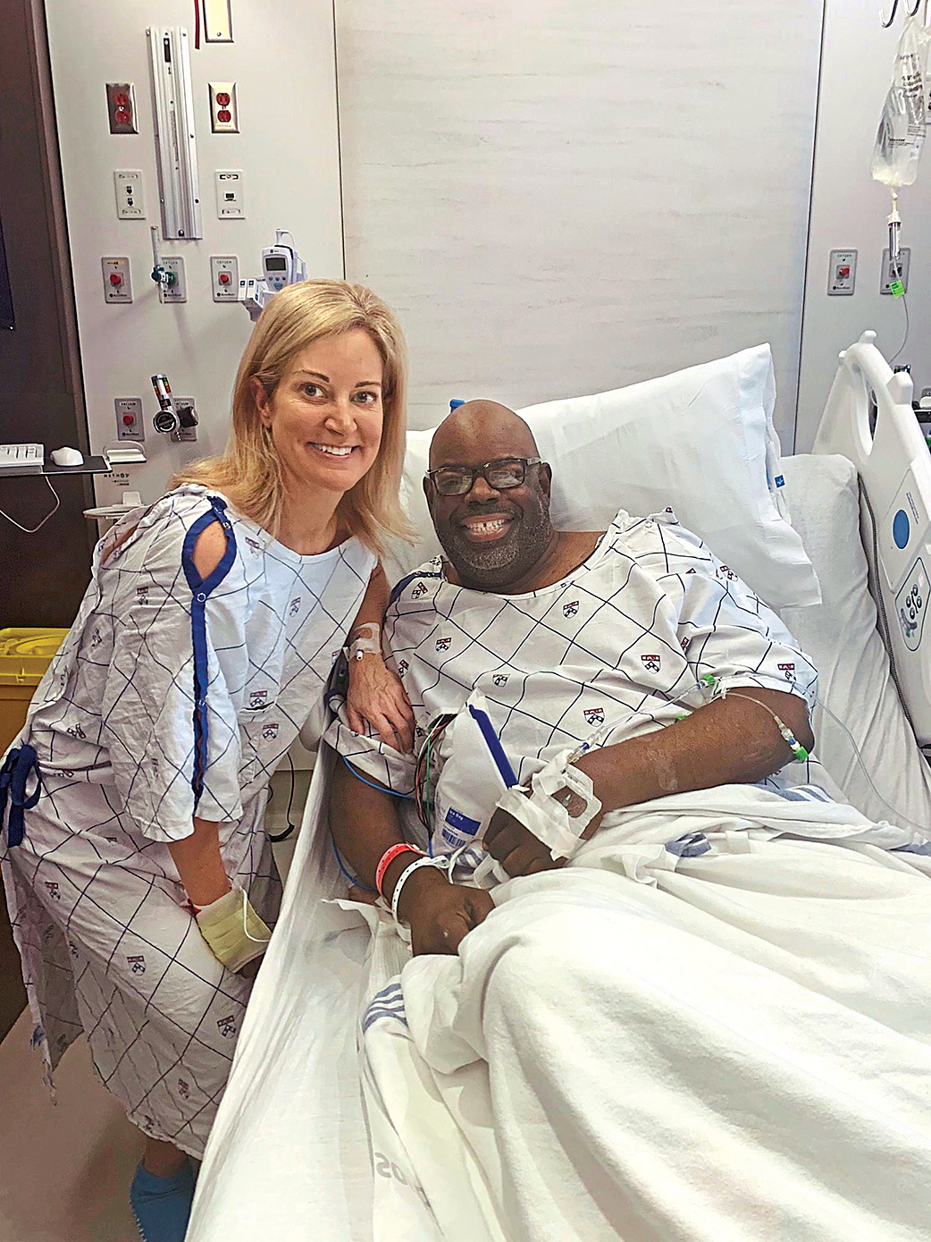 Molly Gray and Dan Napoleon posing in hospital following their kidney donation surgeries