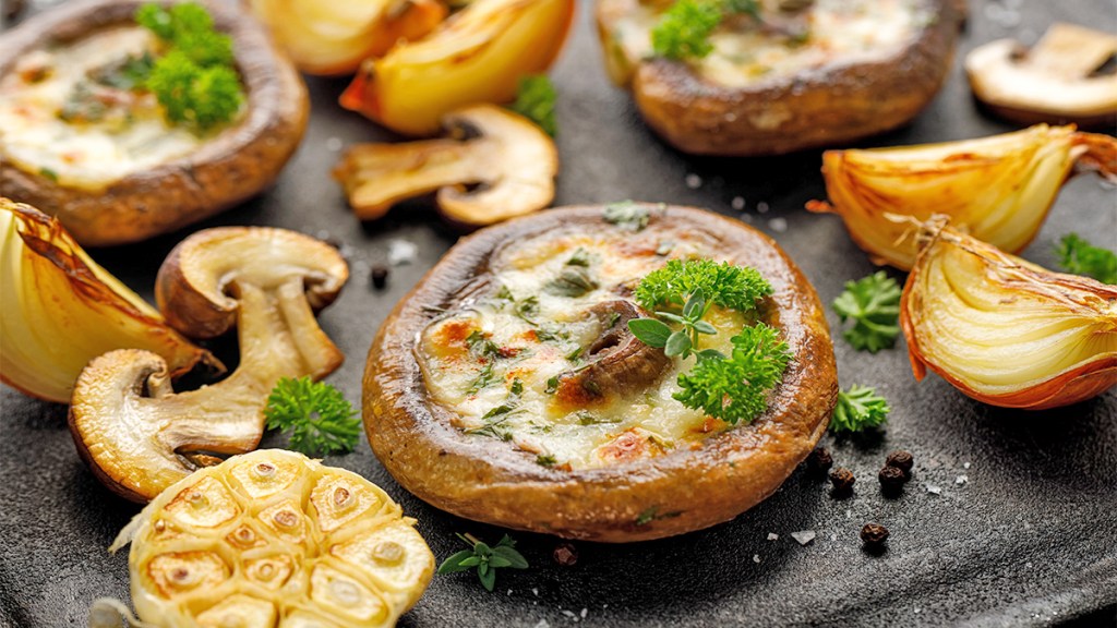 Stuffed portobello mushrooms as part of a guide answering the question "What does Halloumi cheese taste like?"