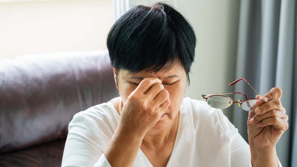 Woman feeling eye or headache pain