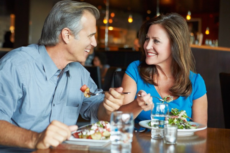 Mature Couple Enjoying Meal In Restaurant