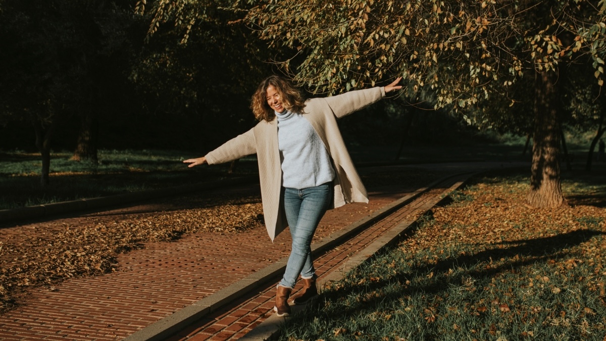 A woman balancing outdoors to help prevent falls