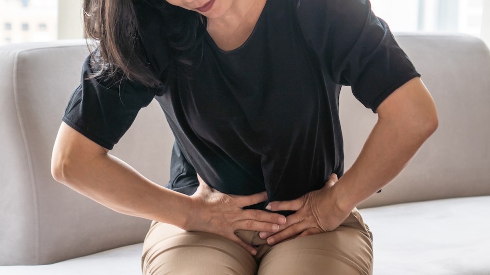 Women clutching lower abdomen in pain