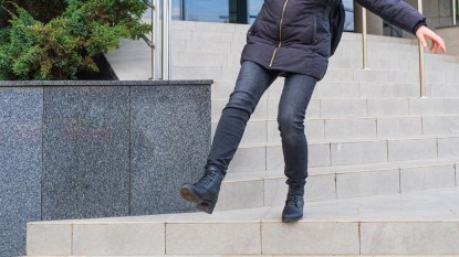 Woman losing balance on steps
