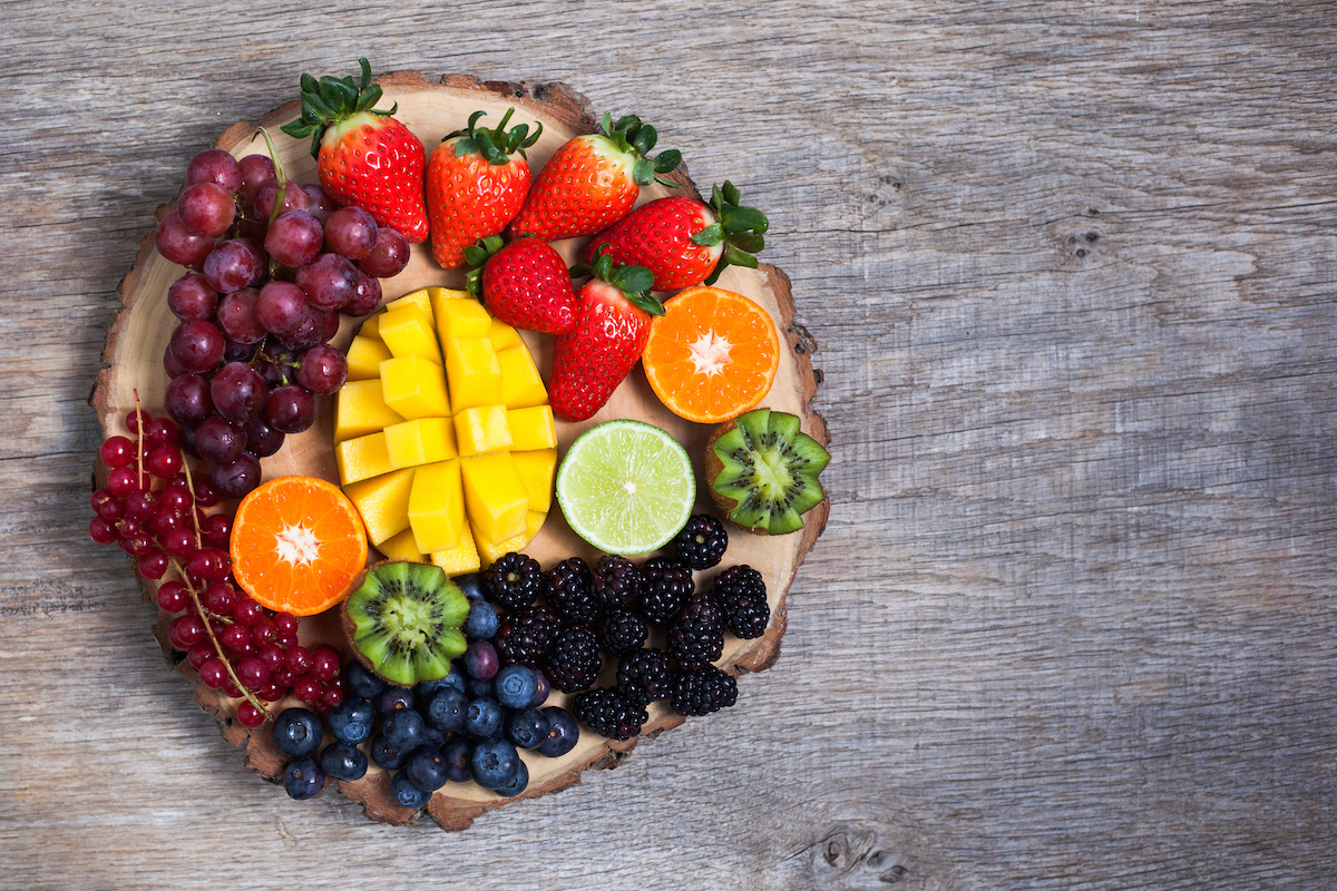 "Fruitcuterie" board with berries, mango, kiwi, orange, lime, and other fruits