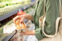 Woman buying eggs at the grocery store
