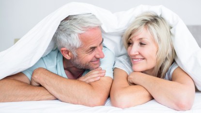 Man and woman looking at each other in bed