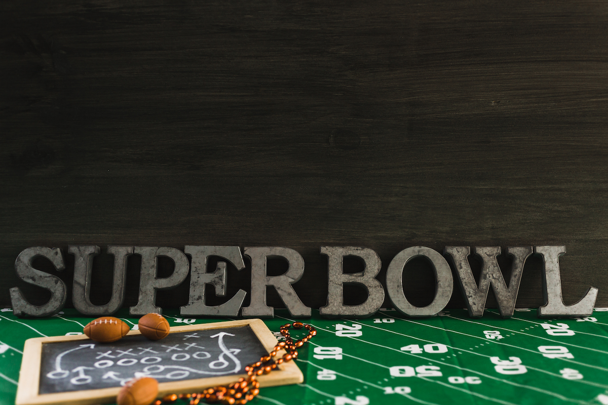 Super Bowl party setup with football tablecloth
