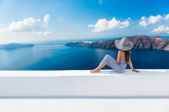 Woman looking at the ocean in Greece