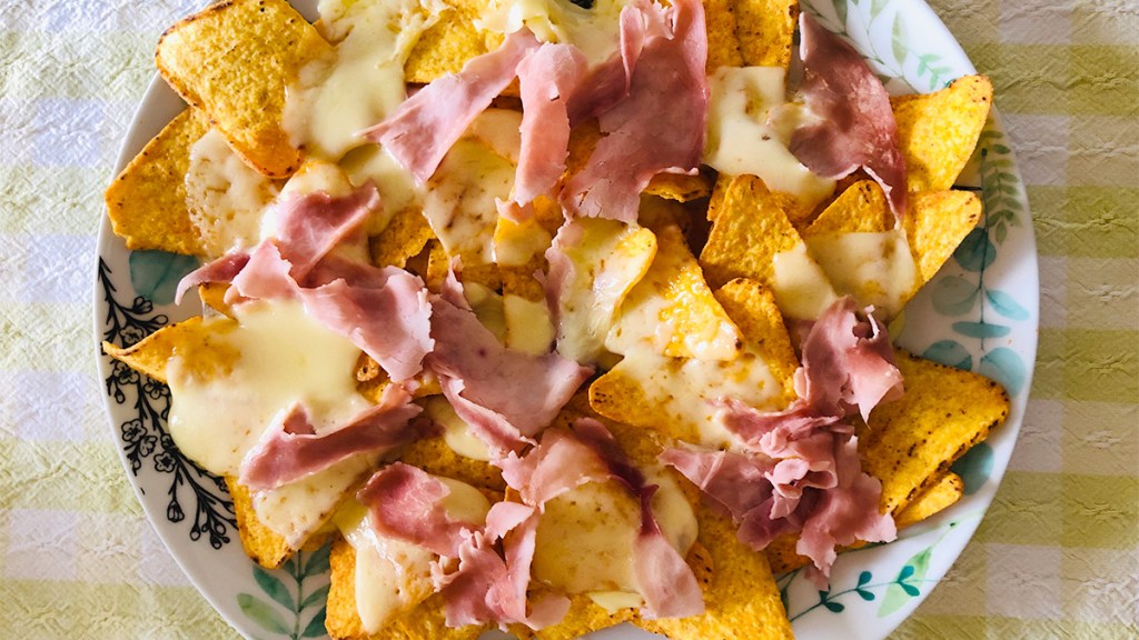 Nachos with ham and cheese as part of a guide on nacho variations