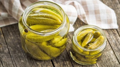 Pickles in a jar as part of a guide on using leftover pickle juice for cooking