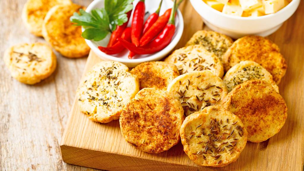 Savory cookies on a wooden board as part of a roundup of cookie recipes