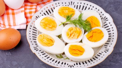 Sliced hard boiled eggs as part of a guide on how to keep them from cracking when they're boiling