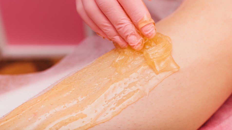 Close-up of woman's leg getting sugared