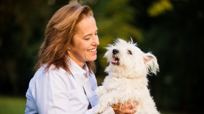 Woman smiling at her dog