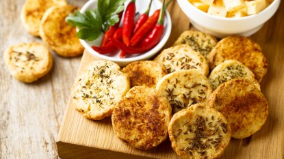 Savory cookies, peppers, and cheese on wood platter