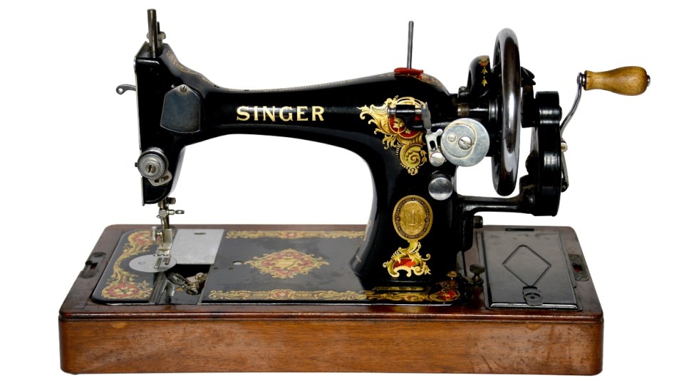 vintage singer sewing machine against white background