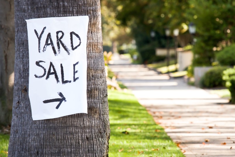 Yard sign sale hanging on a tree outside