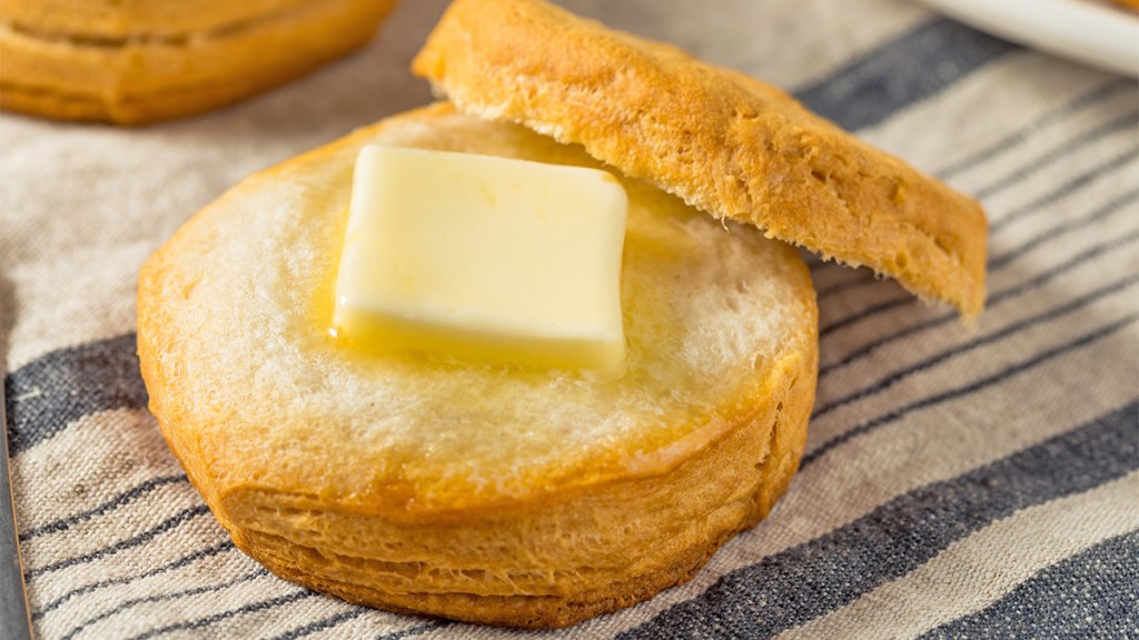 A homemade buttermilk grated butter biscuit with extra butter on top
