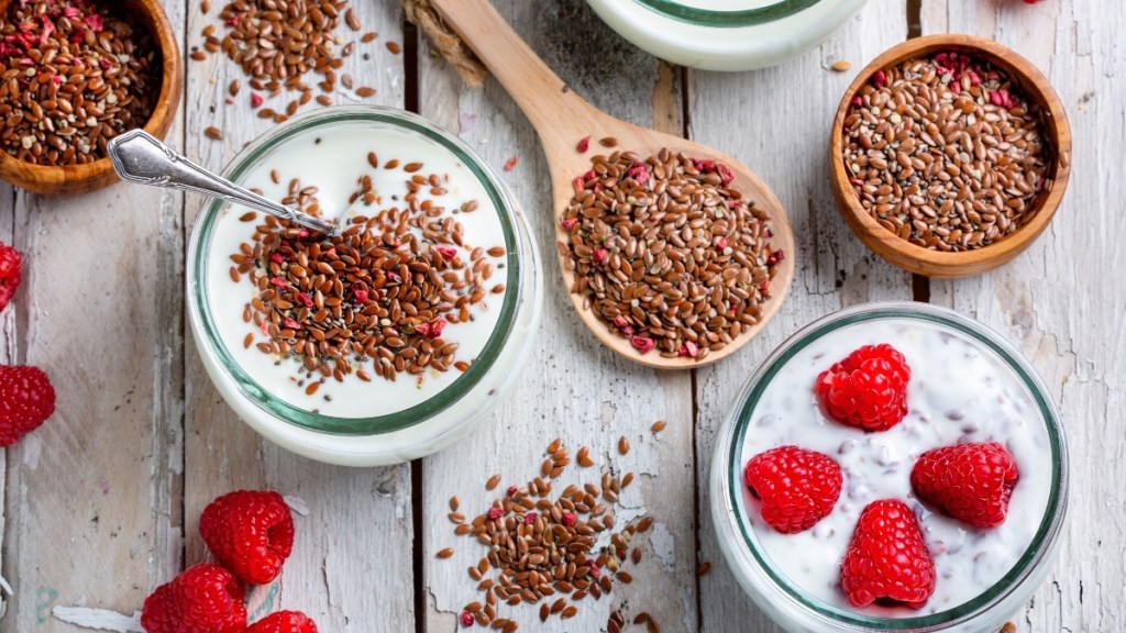 Bowls of yogurt with raspberries and flaxseeds, which are a natural treatment option for urinary incontinence