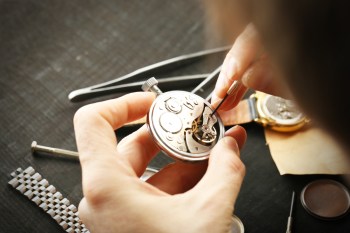 Close-up of hands repairing a watch