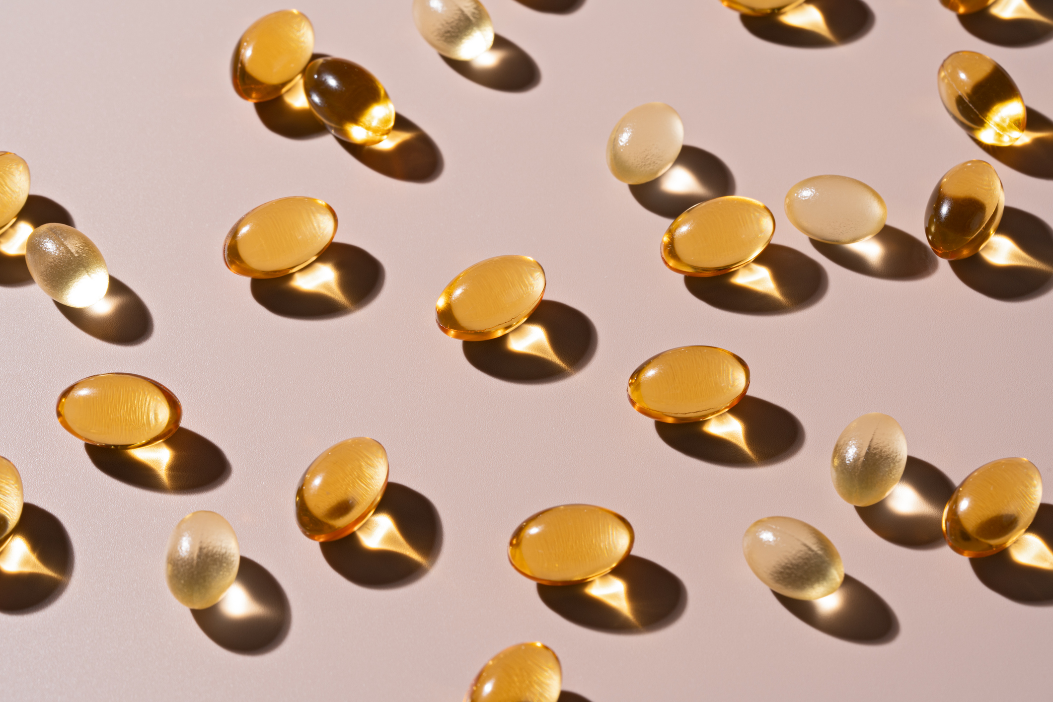 vitamin d capsules on beige background