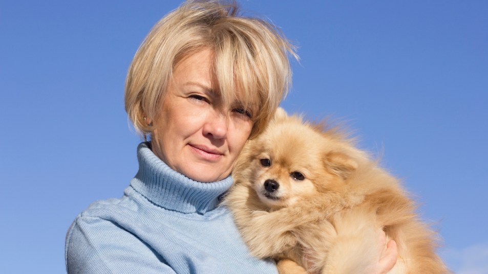 Woman holding Pomeranian dog