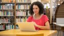 Woman using laptop at public library