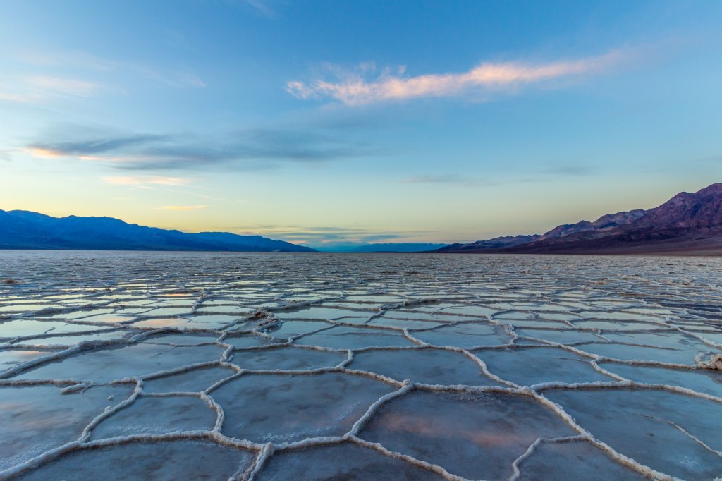Badwater,Basin,At,Sunset.,Salt,Crust,And,Clouds,Reflection.,Death