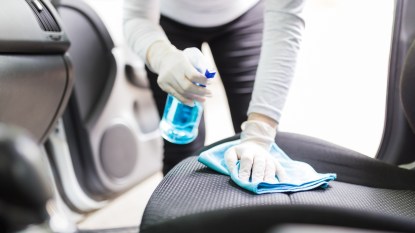 Woman cleaning car seat