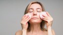 Woman exfoliating face